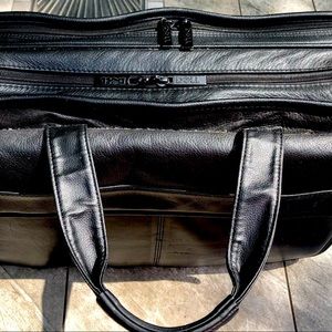 Dell leather computer bag with three pockets.